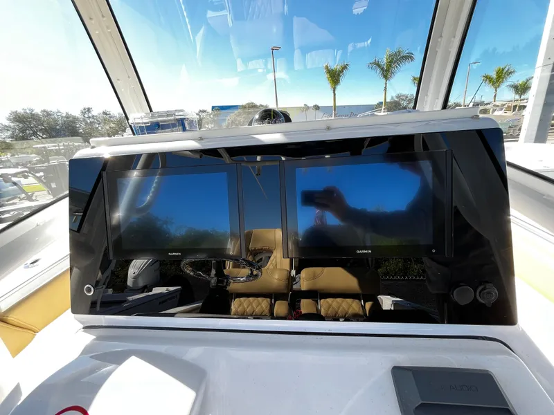 Slide: The Image of 2021 Sportsman Heritage 251 Center Console dashboard with dual display screens. - 22