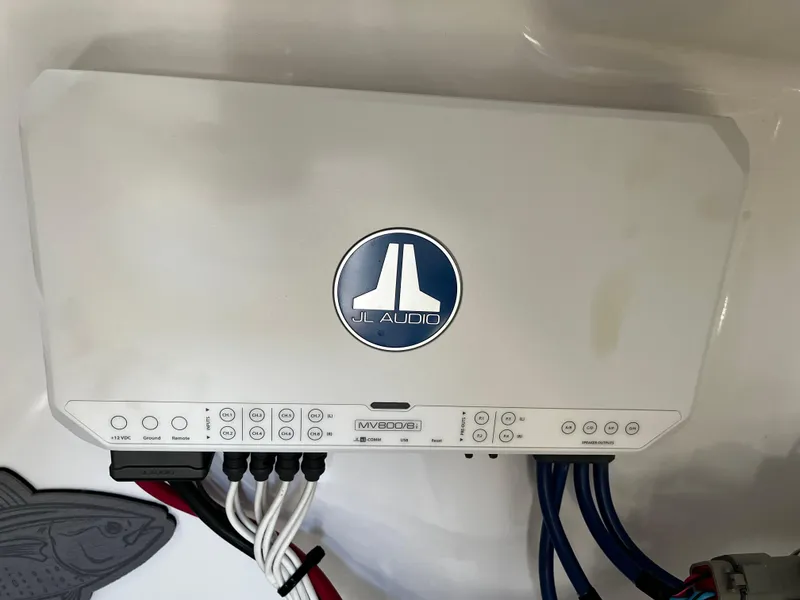 Slide: The Image of JL Audio amplifier in a 2021 Sportsman Heritage 251 Center Console boat. - 31