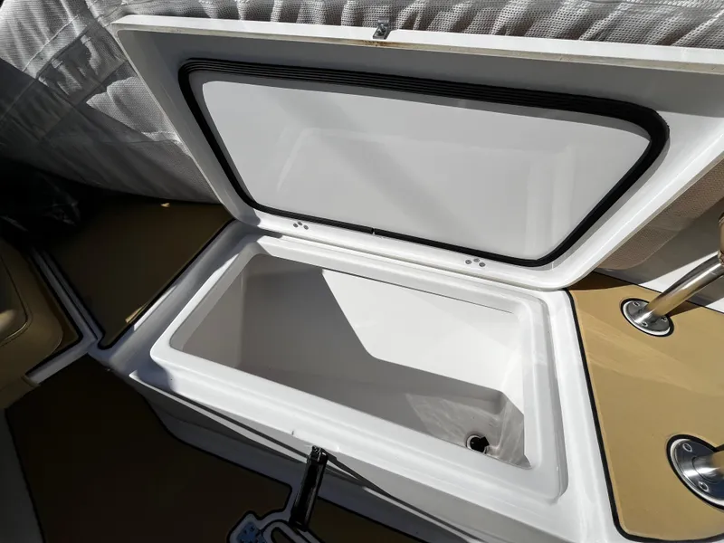 Slide: The Image of Open storage compartment on 2021 Sportsman Heritage 251 Center Console boat. - 34