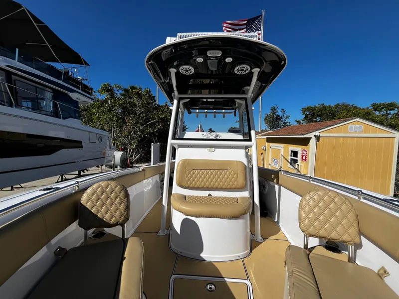 Slide: The Image of 2021 Sportsman Heritage 251 Center Console boat with tan seating and American flag. - 37
