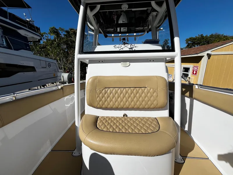 Slide: The Image of 2021 Sportsman Heritage 251 Center Console boat interior with tan cushioned seating. - 38