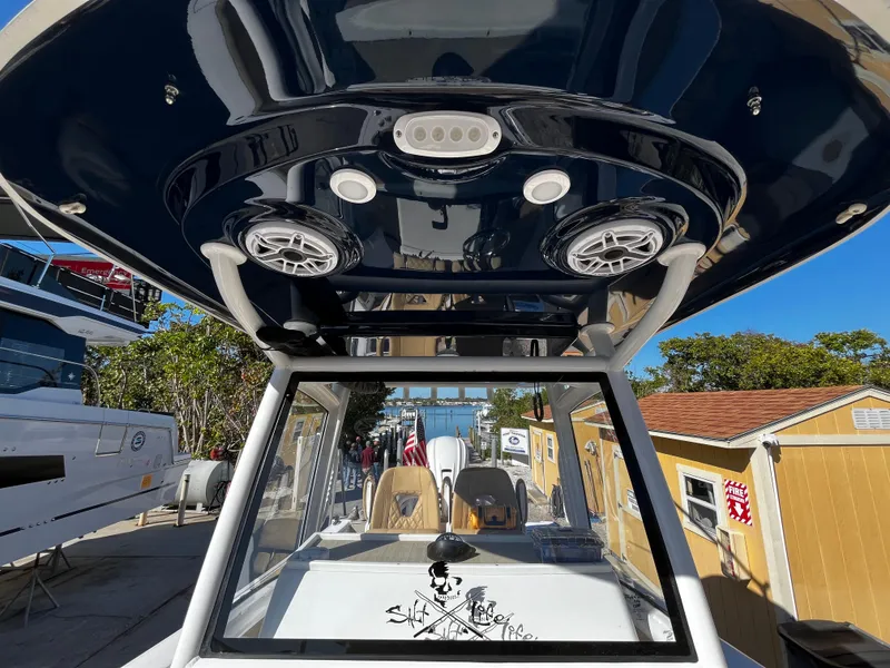 Slide: The Image of 2021 Sportsman Heritage 251 Center Console boat with T-top and speakers. - 39