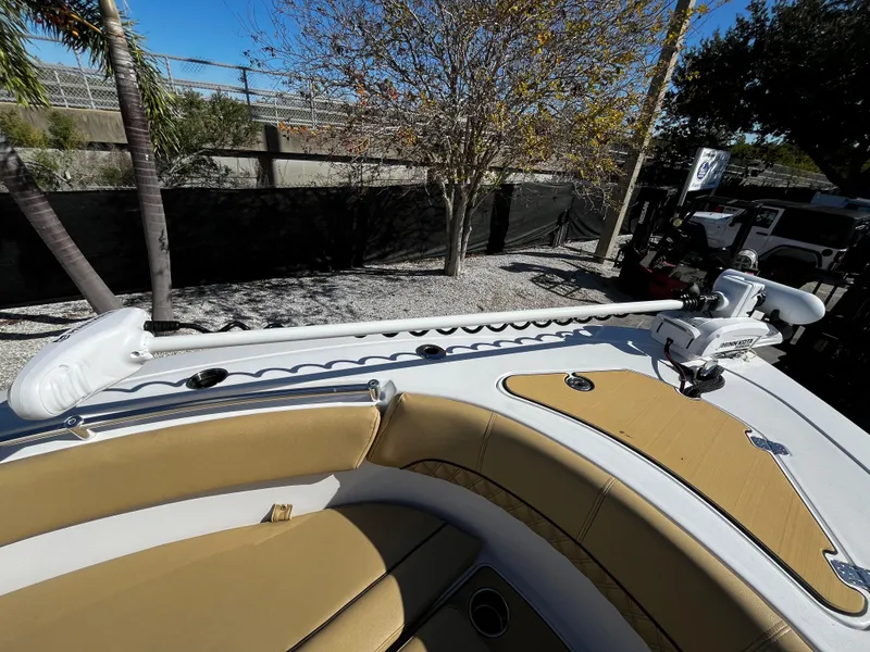 Slide: The Image of 2021 Sportsman Heritage 251 Center Console boat with tan seating and trolling motor. - 40