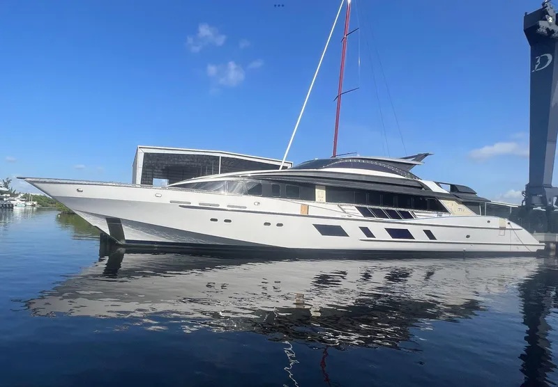 The Image of Heesen 141 Motor Yacht, 1992 model, docked on calm water under a clear blue sky. - 1