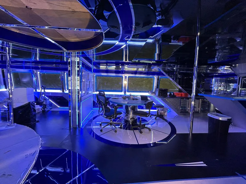 Slide: The Image of Luxurious interior of 1992 Heesen 141 Motor Yacht with modern blue lighting and sleek design. - 21