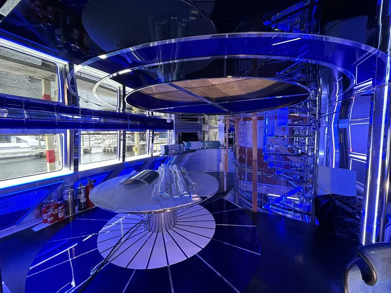 Slide: The Image of Luxurious interior of 1992 Heesen 141 Motor Yacht with modern blue lighting and sleek design. - 22