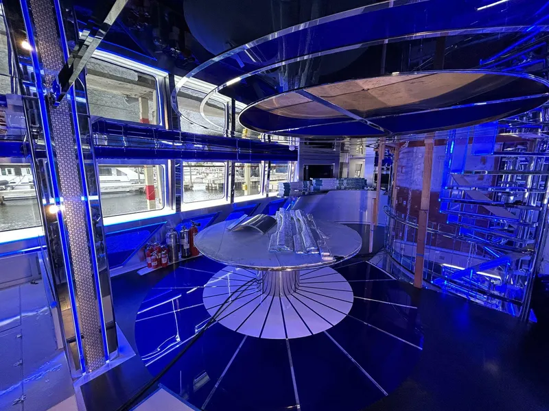 Slide: The Image of Luxurious interior of 1992 Heesen 141 Motor Yacht with modern blue lighting and sleek design. - 24