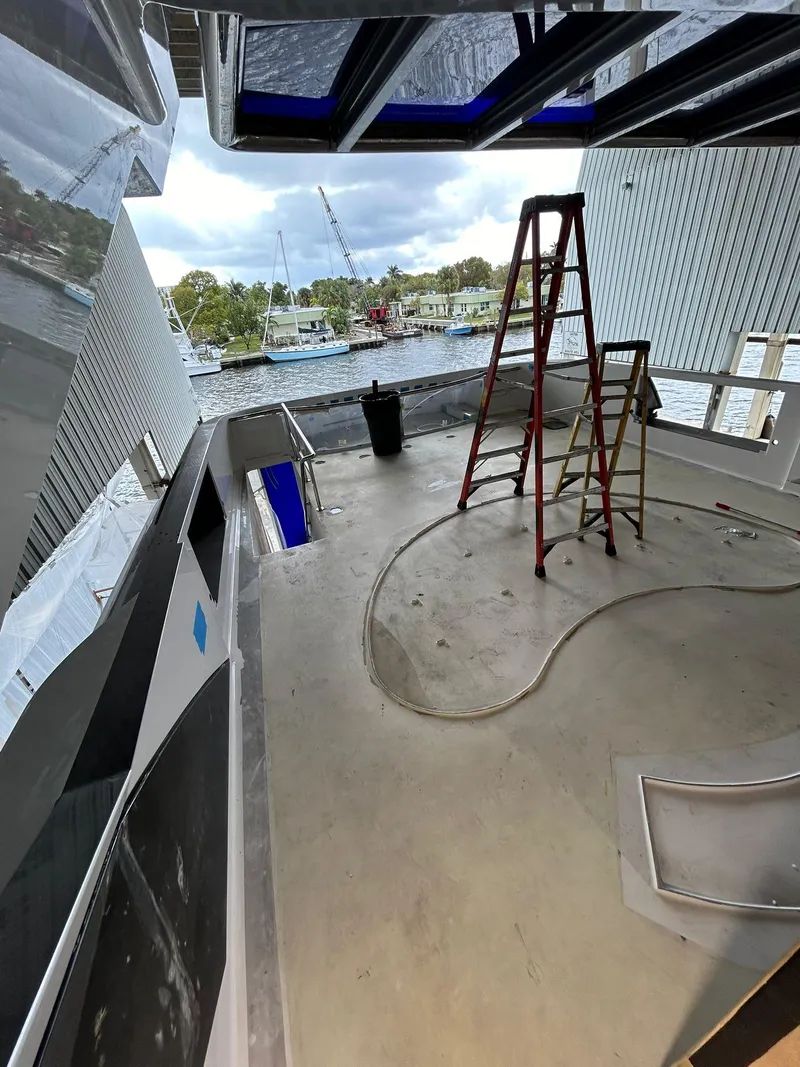 Slide: The Image of Heesen 141 Motor Yacht 1992 under renovation, featuring a ladder and open deck area. - 26