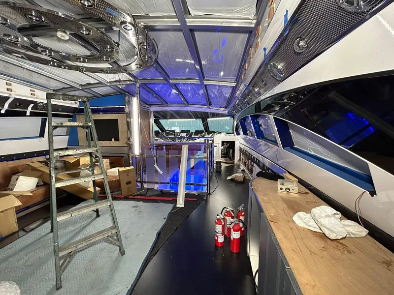 Slide: The Image of Interior of 1992 Heesen 141 Motor Yacht under renovation, featuring tools and fire extinguishers. - 27