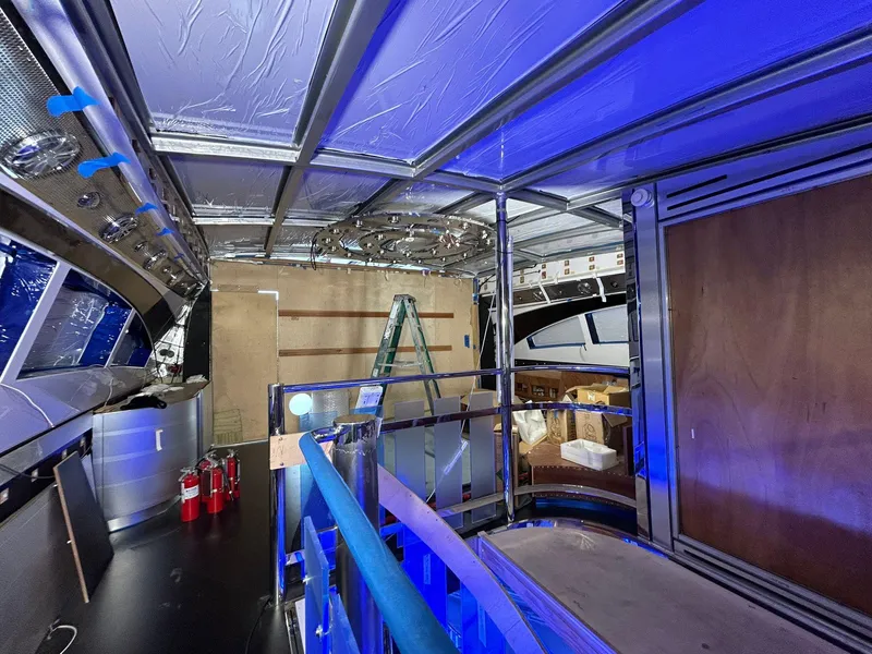 Slide: The Image of Interior view of 1992 Heesen 141 Motor Yacht under renovation with blue lighting. - 29
