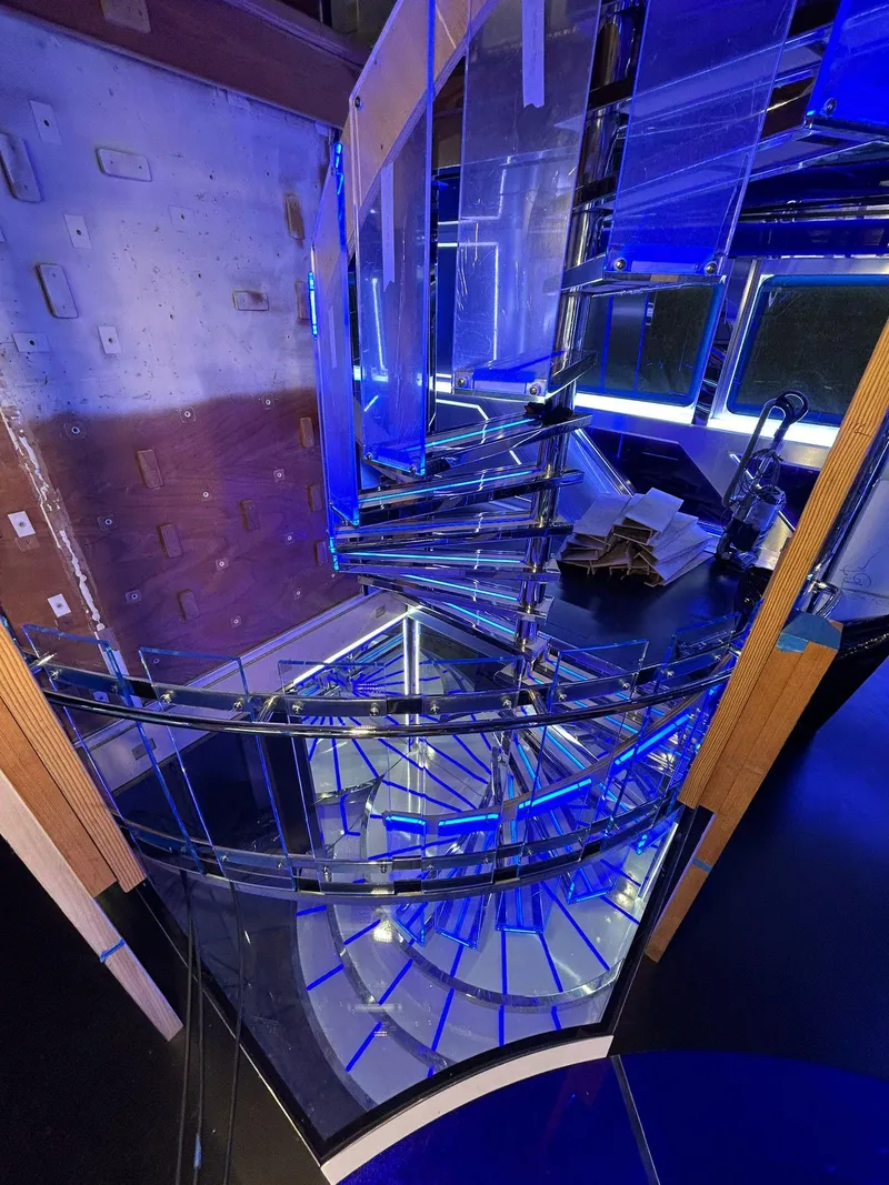 Slide: The Image of Spiral staircase with blue lighting inside a 1992 Heesen 141 Motor Yacht. - 38