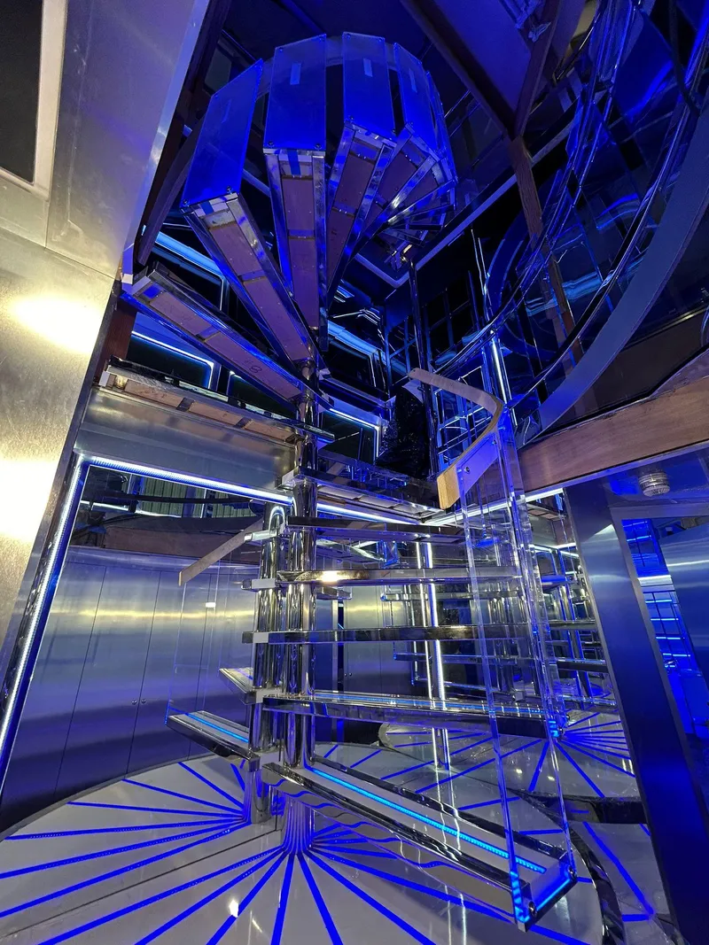 Slide: The Image of Luxurious interior of 1992 Heesen 141 Motor Yacht with modern blue-lit spiral staircase. - 42
