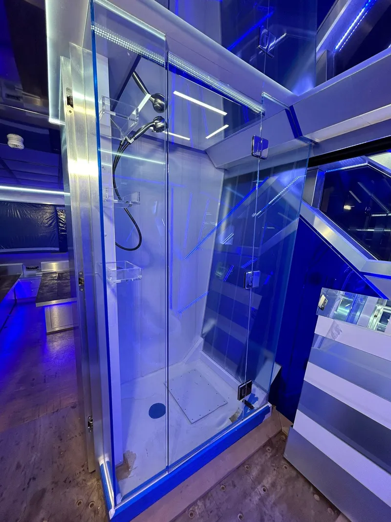 Slide: The Image of Luxurious shower cabin on 1992 Heesen 141 Motor Yacht, featuring modern blue LED lighting. - 44