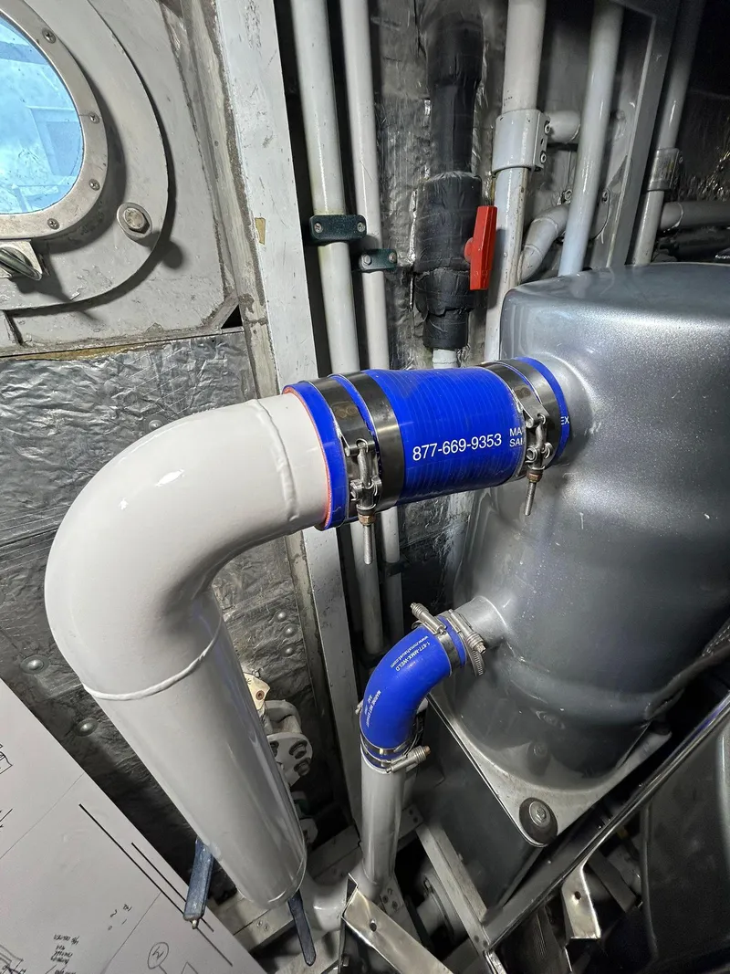 Slide: The Image of Engine room piping in a 1992 Heesen 141 Motor Yacht, featuring blue and white connectors. - 8