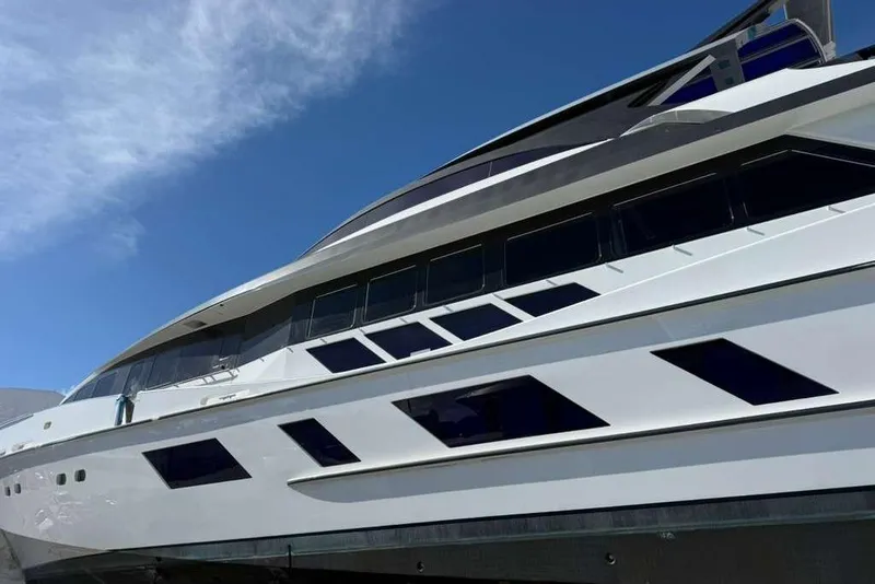Slide: The Image of Heesen 141 Motor Yacht 1992, sleek design against a clear blue sky. - 85