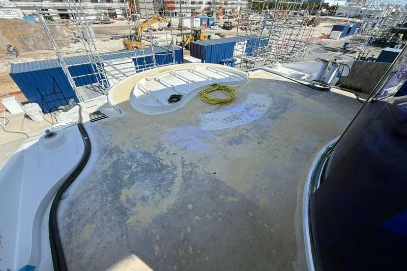 Slide: The Image of Heesen 141 Motor Yacht 1992 under renovation, deck view with construction site background. - 87