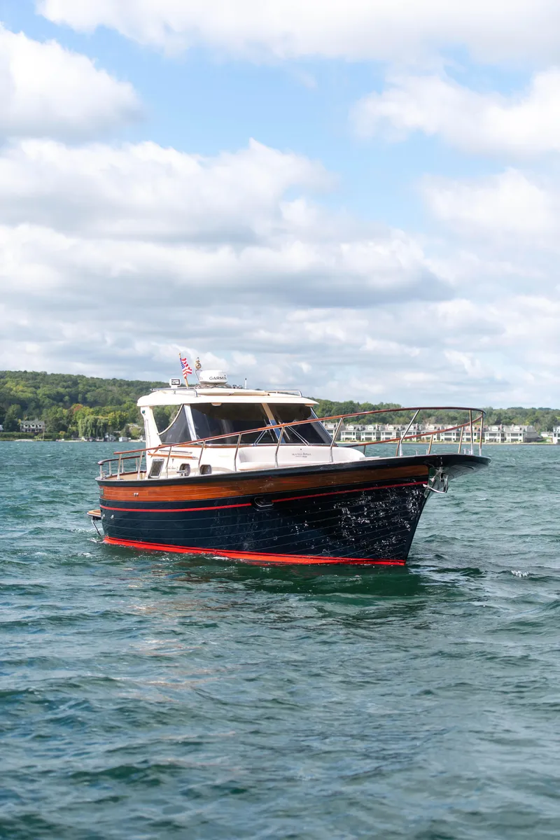 Slide: The Image of Fratelli Aprea Sorrento 32 boat cruising on a lake under a cloudy sky, 2020 model. - 2