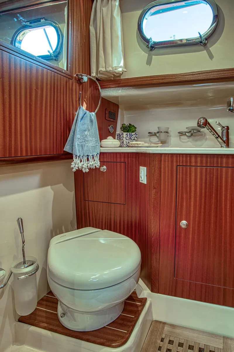 Slide: The Image of Luxurious 2020 Fratelli Aprea Sorrento 32 yacht bathroom with wood accents and porthole windows. - 21