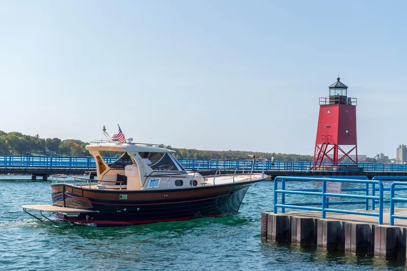 Slide: The Image of Fratelli Aprea Sorrento 32 boat near red lighthouse, 2020 model, on a sunny day. - 26