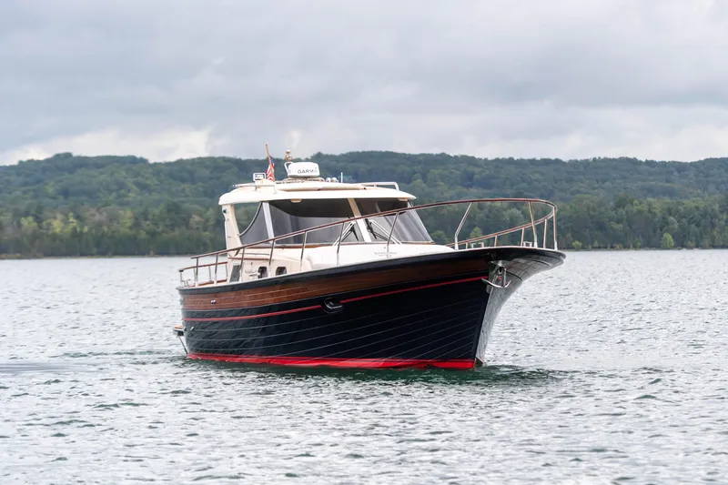 Slide: The Image of 2020 Fratelli Aprea Sorrento 32 boat cruising on a lake with forested background. - 41