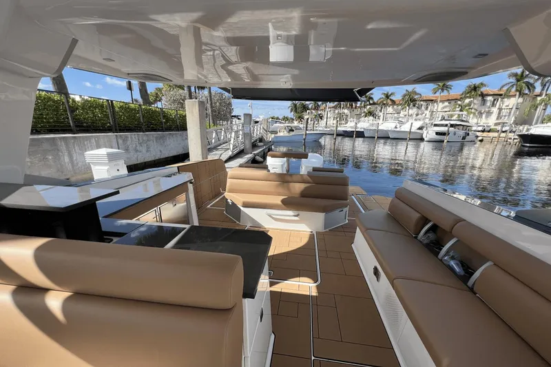 Slide: The Image of Luxurious 2024 Aviara AV40 Outboard interior with tan seating, docked at marina. - 14