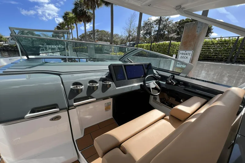Slide: The Image of 2024 Aviara AV40 Outboard helm with modern dashboard and luxurious seating. - 16