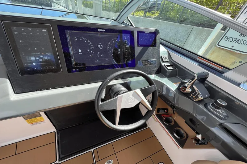 Slide: The Image of 2024 Aviara AV40 Outboard helm with advanced digital displays and controls. - 17