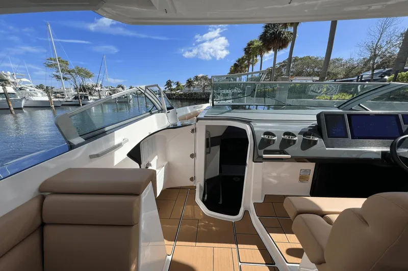 Slide: The Image of 2024 Aviara AV40 Outboard boat interior with luxurious seating and modern dashboard. - 19
