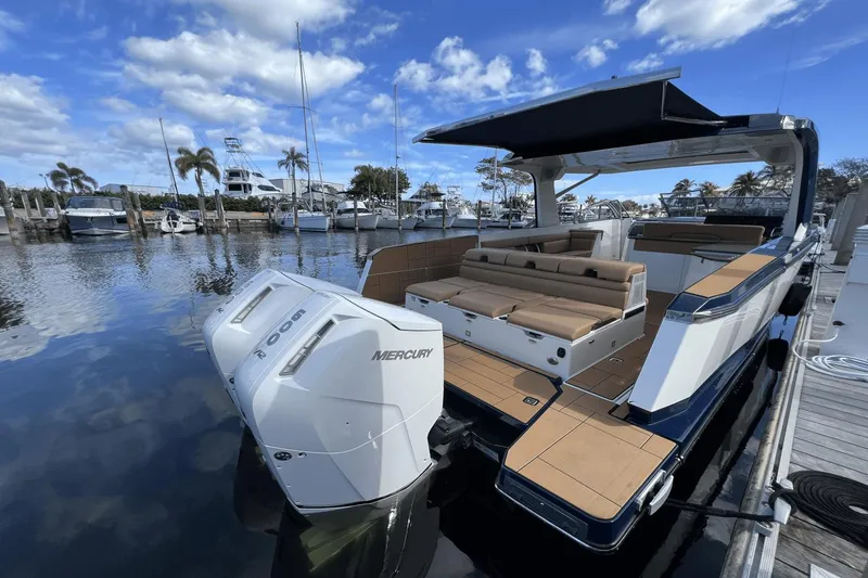 Slide: The Image of 2024 Aviara AV40 Outboard luxury boat docked with twin Mercury engines. - 2