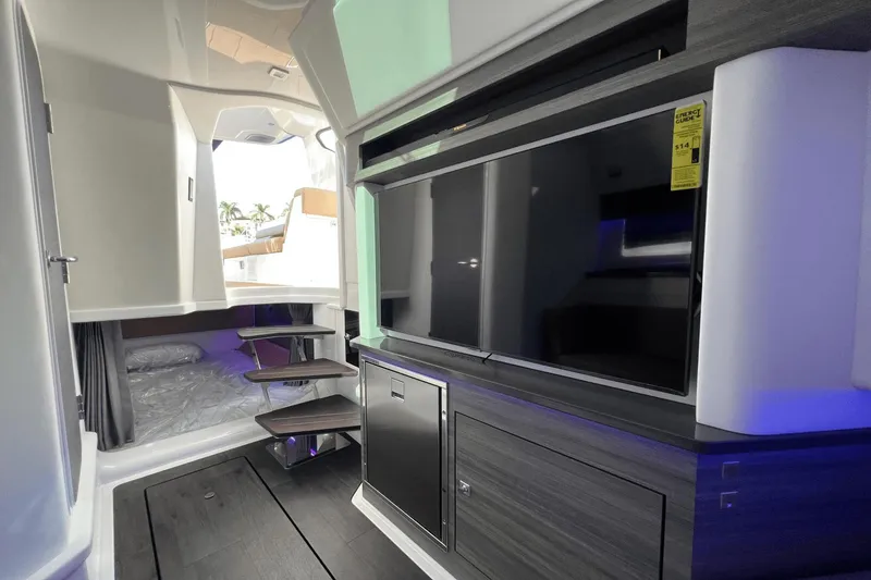 Slide: The Image of 2024 Aviara AV40 Outboard interior with modern design, TV, and cozy sleeping area. - 21