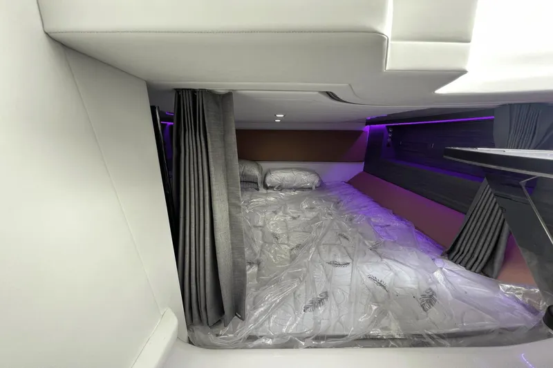 Slide: The Image of 2024 Aviara AV40 Outboard cabin interior with bed and ambient lighting. - 23