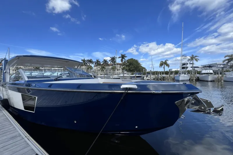 Slide: The Image of 2024 Aviara AV40 Outboard boat docked at marina under blue sky. - 28