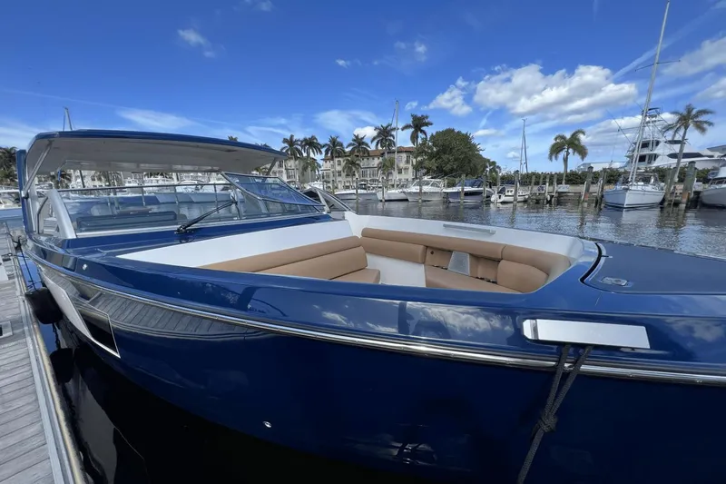 Slide: The Image of 2024 Aviara AV40 Outboard boat docked at marina, featuring sleek design and spacious seating. - 29