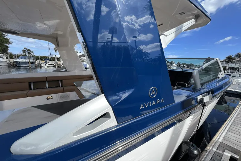Slide: The Image of 2024 Aviara AV40 Outboard luxury boat docked, showcasing sleek design and modern features. - 4