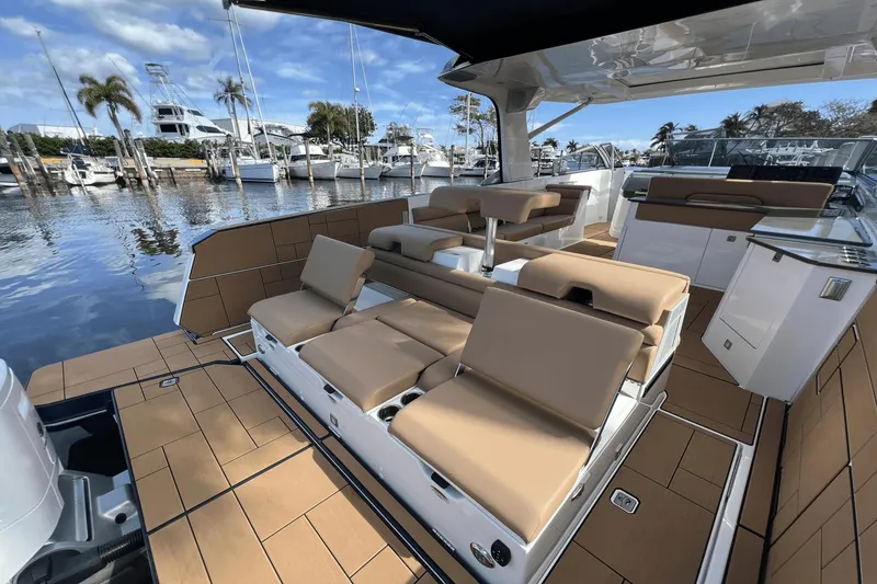 Slide: The Image of 2024 Aviara AV40 Outboard luxury boat interior with tan seating and sleek design. - 6