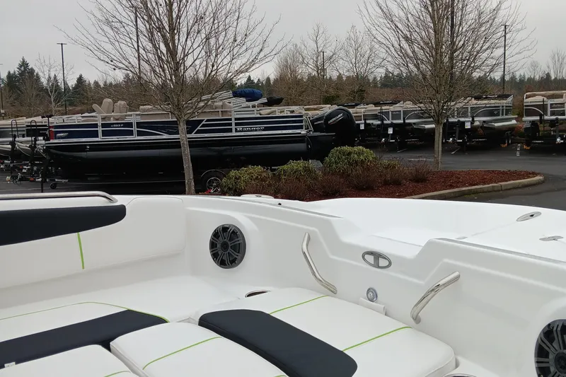 Slide: The Image of 2024 Tahoe 1950 boat in a parking lot with other boats in the background. - 3