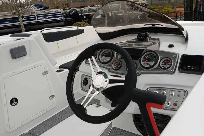 Slide: The Image of 2024 Tahoe 1950 boat dashboard with steering wheel and control panel. - 4