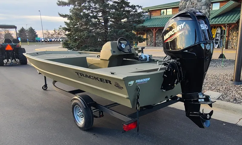 Slide: The Image of 2024 Tracker Grizzly 1648 SC boat with Mercury 50 engine on trailer. - 2