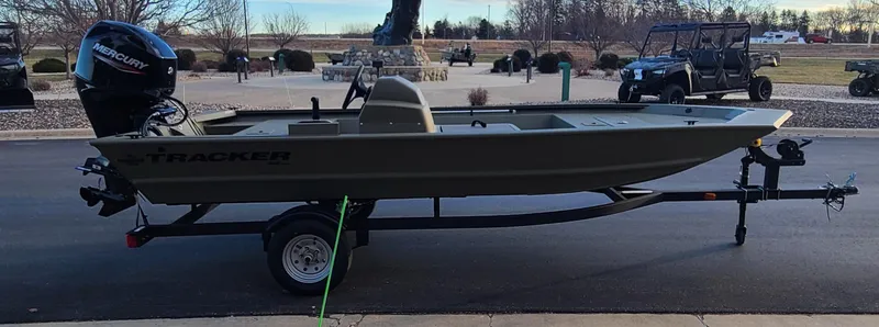 Slide: The Image of 2024 Tracker Grizzly 1648 SC boat on trailer, parked outdoors. - 5