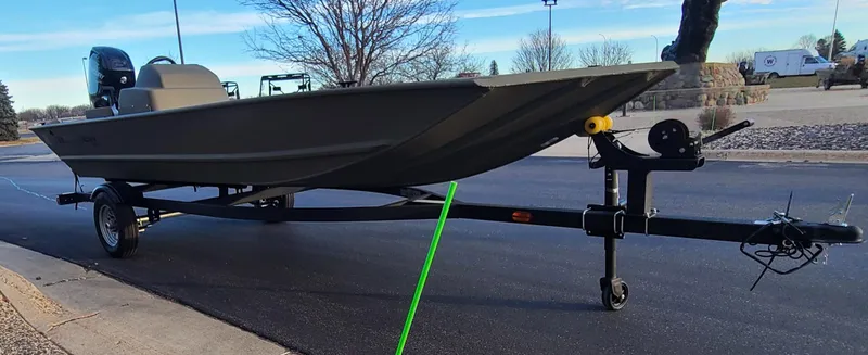 Slide: The Image of 2024 Tracker Grizzly 1648 SC boat on trailer, parked outdoors. - 6