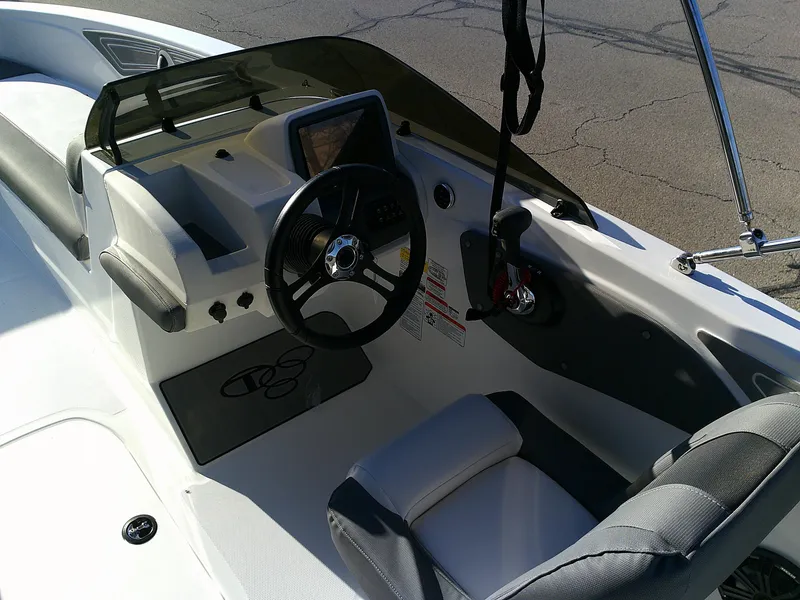 Slide: The Image of 2024 Tahoe T21 boat cockpit with steering wheel and control panel. - 2