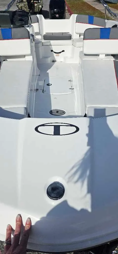 Slide: The Image of 2024 Tahoe T18 boat with white deck and blue seating. - 2