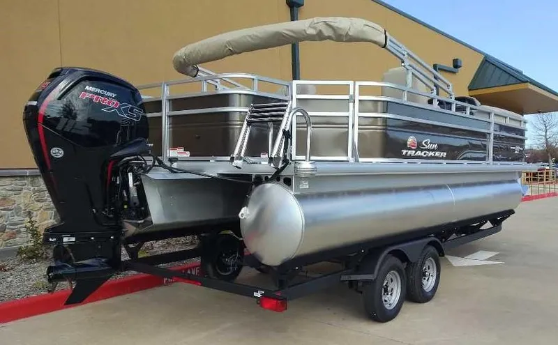 Slide: The Image of 2024 Sun Tracker SportFish 22 DLX pontoon boat on trailer with Mercury outboard motor. - 4