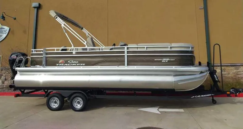 Slide: The Image of 2024 Sun Tracker SportFish 22 DLX pontoon boat on a trailer. - 8
