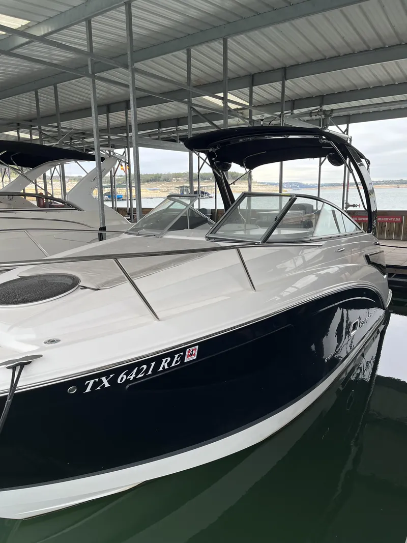 Slide: The Image of 2022 Regal 26XO boat docked in a covered marina. - 11