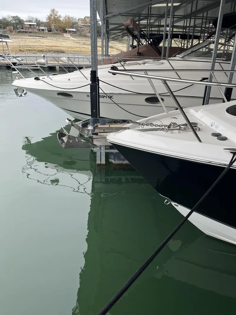 Slide: The Image of 2022 Regal 26XO boats docked in a marina, calm water reflections. - 12