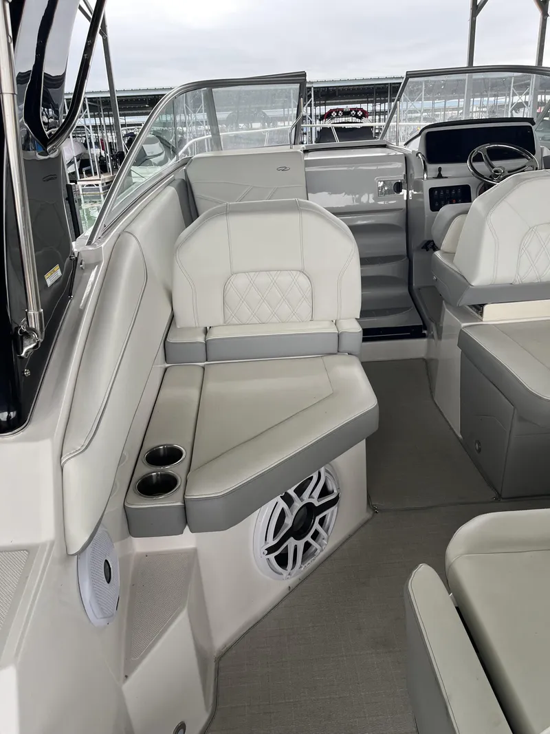 Slide: The Image of 2022 Regal 26XO boat interior with plush seating and modern dashboard. - 13