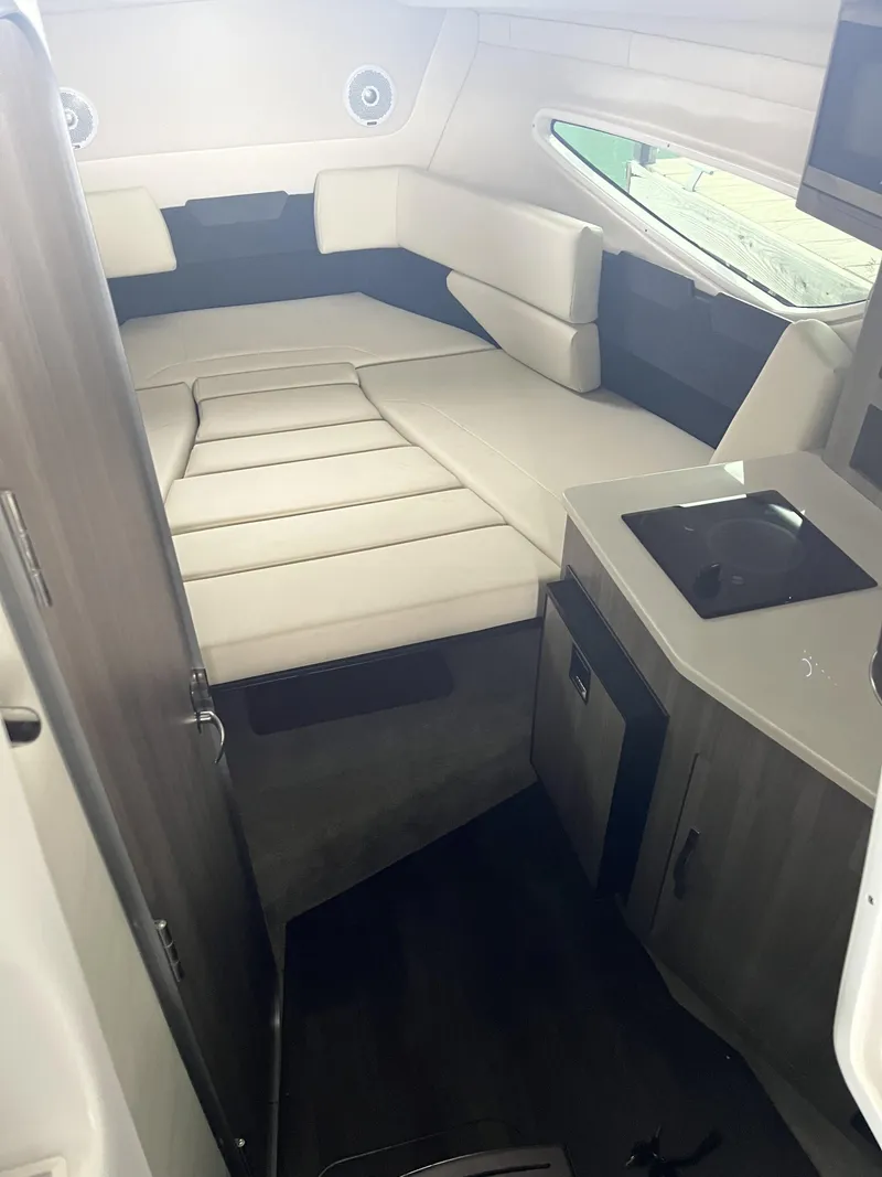 Slide: The Image of 2022 Regal 26XO boat interior with cozy cabin and kitchenette. - 15