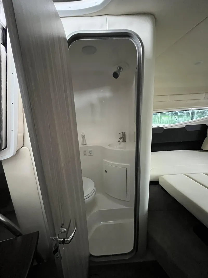 Slide: The Image of 2022 Regal 26XO boat interior bathroom with compact design and modern fixtures. - 18