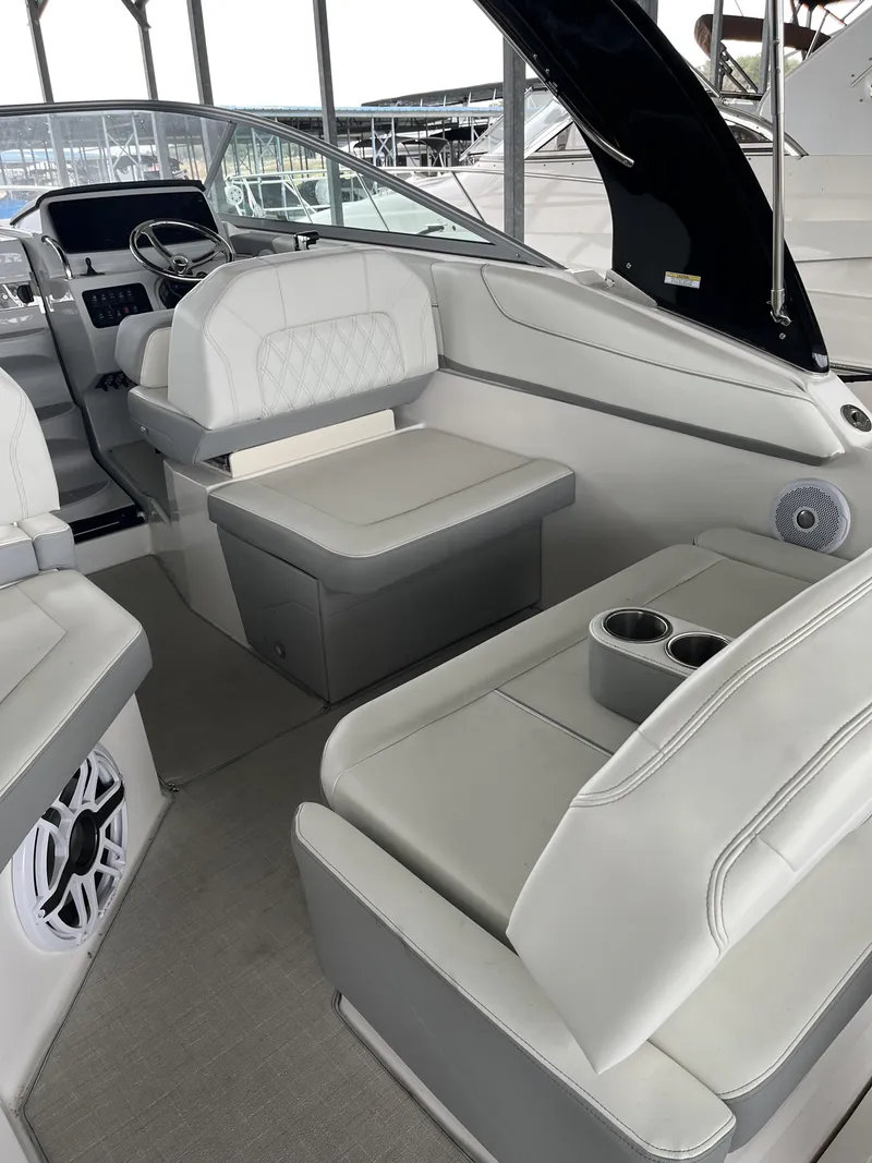 Slide: The Image of Interior of 2022 Regal 26XO boat with white seating and modern dashboard. - 3